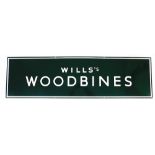 A large enamel advertising sign marked Wills's Woodbines, on green and white enamelling, 153cm wide,