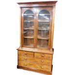 An early 19thC mahogany bookcase, with moulded cornice top above two astragal glazed doors, on turne