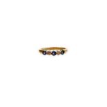 A 9ct gold five stone dress ring, set with imitation diamond and sapphire stones, in a platinum claw