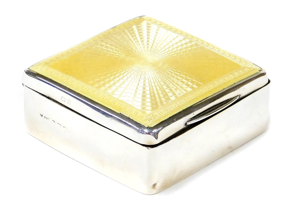 A George V silver and enamel cigarette box, the rectangular top with yellow enamelled decoration, li