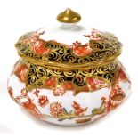 A Royal Crown Derby miniature jar and cover, with Imari type decoration picked out in gilt with red