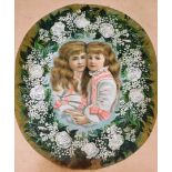 An oval Victorian coloured lithograph of two young girls, surrounded by flowers, in a maple frame, w