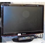 A Samsung 23½" LCD television, with remote control, and a Humax digital box with remote. (2)
