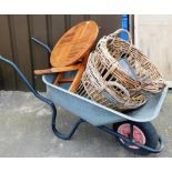 Various outdoor effects, to include a wheelbarrow, table, two wicker baskets and a bucket. (a