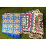 Two throws, comprising one woollen knitted throw, and another of flowers. (2)