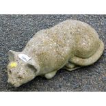 A stone garden ornament of a prowling cat.