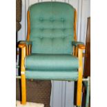 A beech framed armchair, with turquoise upholstered cushions.