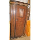 A stained oak Old Charm single wardrobe, with carved panelled decoration, on a shaped base, 186cm