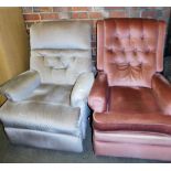 Two reclining armchairs, one in grey upholstered fabric, the other in pink.