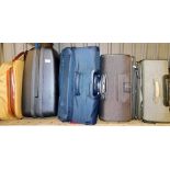 Various suitcases, to include a hard shell case, a tan leather canvas case, three material cases,