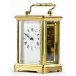 A French brass carriage clock, with a loop handle, the white enamel dial with Roman numerals, 14cm