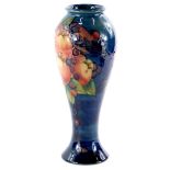 A Moorcroft pottery baluster shaped vase, decorated with pomegranates, birds, berries etc.,