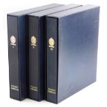 Three Stanley Gibbons stamp albums, containing a collection of world and British stamps, etc.