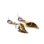 A pair of Art Nouveau style amethyst and silver drop earrings, the tear drop cut amethyst studs with