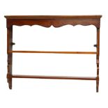 A mahogany wall shelf, with a moulded cornice above a shaped apron and two shelves, 72cm high,