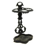 A cast iron four division umbrella stand in Victorian style, decorated with leaves with trefoil