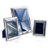 A modern silver rectangular photo frame, with egg and dart moulded embossed band, 21cm x 16cm, and