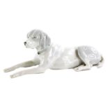 A continental porcelain model of a hound, with mottled decoration, 27cm long.