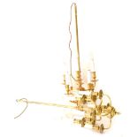 A pair of brass effect two tier chandeliers, each with six simulated candle fittings, 92cm high x