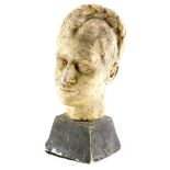 A carved plaster bust, modelled in the form of a lady with plaited hair, on a tapering base,