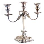 A silver plated three branch candelabrum, engraved 'presented to Inspector BJ Rowe on his retirement