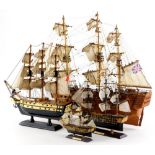 A scale model of a three masted ship, another smaller ship, and two models of HMS Victory. (4)