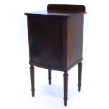 An Edwardian mahogany and ebony strung bow fronted pot cupboard, with a raised back, with a plain