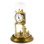 A Keininger and Obergfell brass Anniversary type clock, with a white enamel dial and a glass dome,