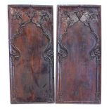 A pair of carved walnut panels, each decorated with flowers, leaves etc., 96cm x 42cm.