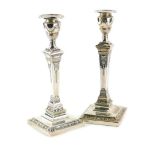 A pair of Edwardian silver candlesticks, each cast with swags, patera, etc., in Adam style, with a