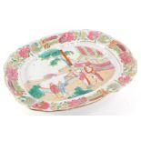 A 19thC Staffordshire meat dish, printed and painted with oriental scenes, within a floral