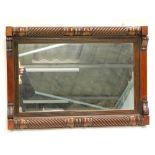 An early Victorian mahogany wall mirror, with turned and reeded pilasters, a reeded slip and a