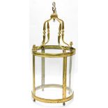 A large brass lantern, with four curved glass panels, 120cm high, 54cm diameter.