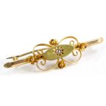 A Victorian bar brooch, set with a tiny diamond in an illusion setting, surrounded by floral