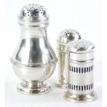 An Edwardian silver baluster shaped pepper pot, London 1906, 9cm high, and a pair of smaller