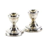 A pair of Elizabeth II dwarf candlesticks, loaded bases, Sheffield 1972, 6cm high. (2)