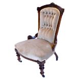 A late Victorian walnut nursing chair, with a padded button back, a padded seat on turned legs, with