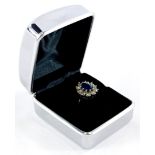 A sapphire and diamond floral cluster ring, the central oval cut sapphire measuring 8.8mm x 6.6mm