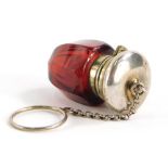A cranberry glass vinaigrette, the stopper cast with scrolls, leaves, etc., with chain handle and