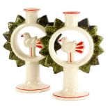 A pair of Lisa Larson design Swedish candlesticks, each moulded with a central bird around a