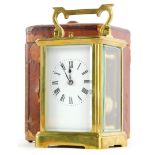 A brass carriage clock, with hour repeat, the white enamel dial with Roman numerals, the case with a