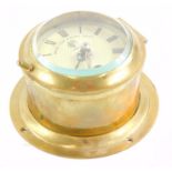 A brass cased ship's clock or timepiece, stamp to the dial Made For Royal Navy, London, 13cm