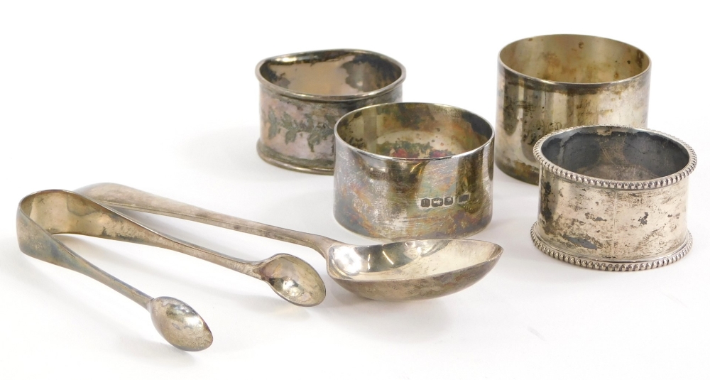 A collection of small silver, to include sugar tongs, napkin rings, 4cm diameter, spoon, etc., 4½