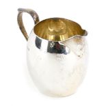 An Edwardian silver cream jug, of plain form, with thumb mount ear shaped handle, London 1908, 2¾oz,