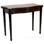 A George III mahogany card table, the serpentine shaped top with a carved border, enclosing a