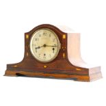An early 20thC mahogany cased mantel clock, with a silvered dial, the case inlaid in mother of pearl