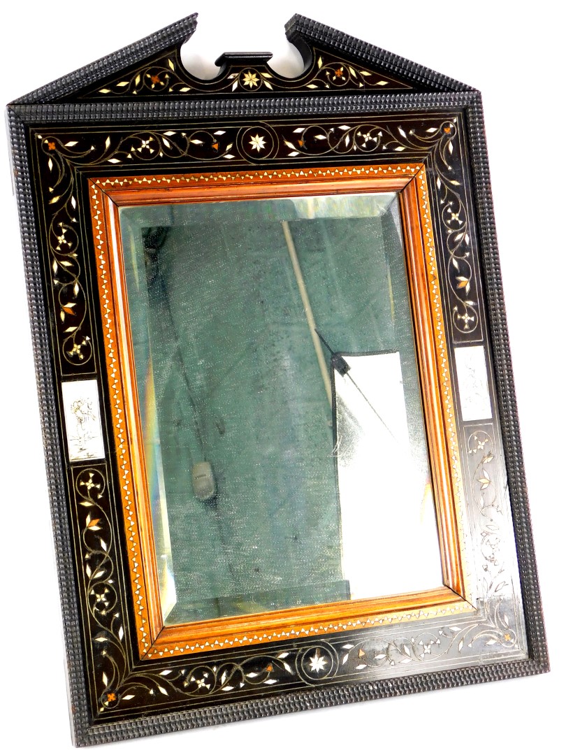 A late 19thC continental ebony, bone and marquetry wall mirror, with a broken pediment, a ripple