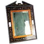 A late 19thC continental ebony, bone and marquetry wall mirror, with a broken pediment, a ripple