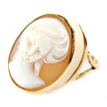 A shell cameo dress ring, with oval cameo depicting a maiden quarter profile, in rub over setting,