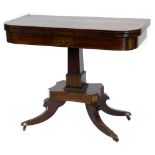 A Regency rosewood and brass inlaid card table, the D shaped top with a crossbanded border,